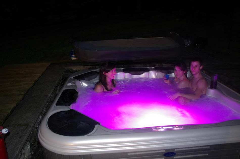 Scottish holiday guests relax in hot tub