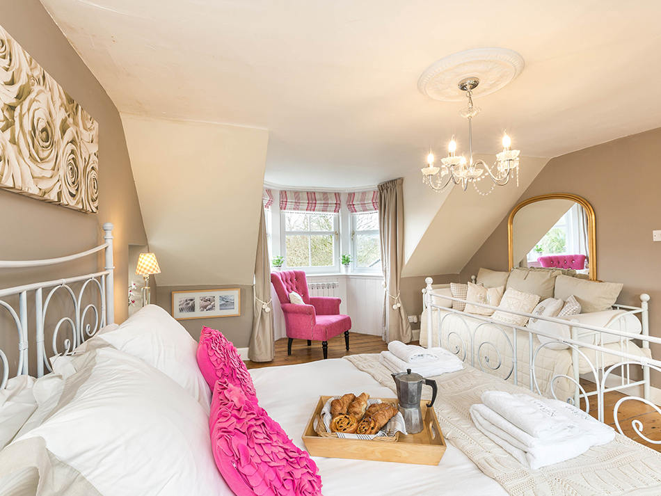 A large double master bedroom on the top floor overlooking the garden