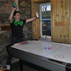 Guests playing Air Hockey table at Scottish Holiday House