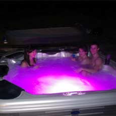 Scottish holiday guests relax in hot tub