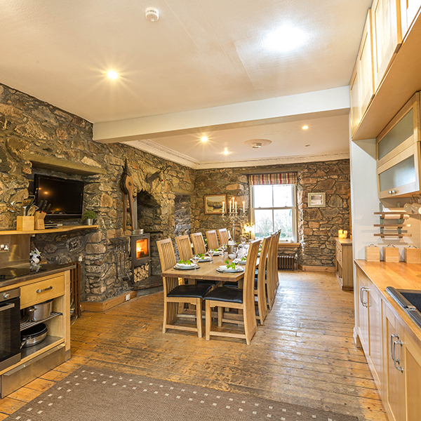 The open plan kitchen is spacious and modern with a large table for 12